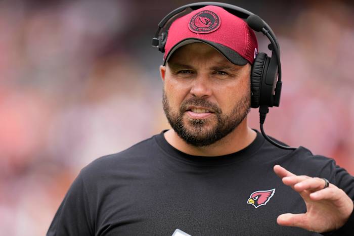 Cardinals offensive line coach Klayton Adams walks on the sideline before the game against the Commanders.